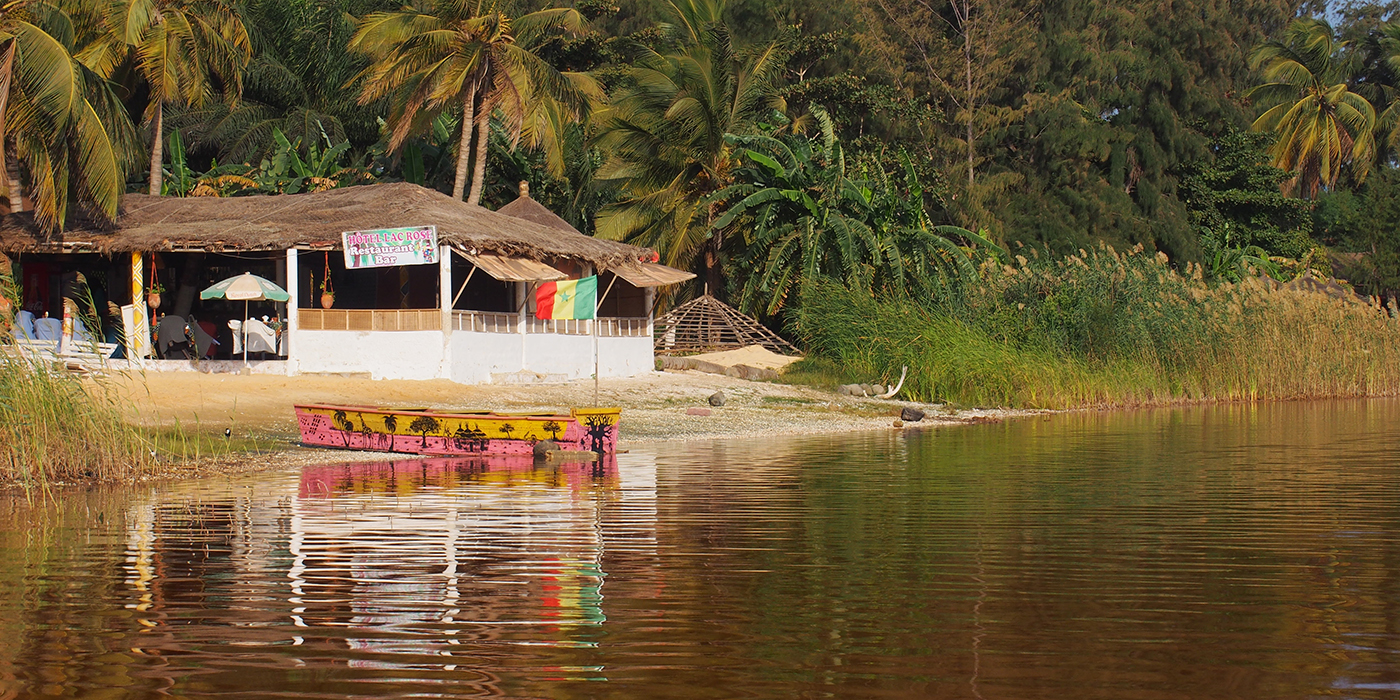 Slightly reddish pink lake and hut, Lac Rose, Dakar, Senegal